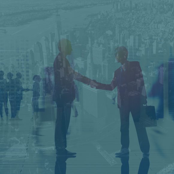 Double exposure image of two men shaking hands